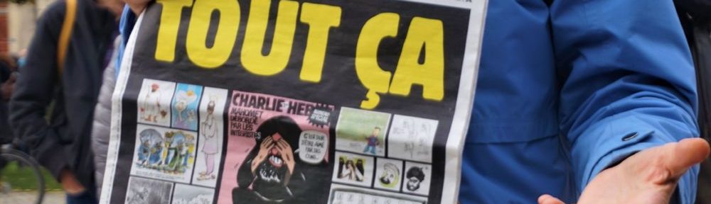 Une manifestante exhibe le numéro de Charlie Hebdo sorti début septembre © Simon Marseille – Place Gre’net