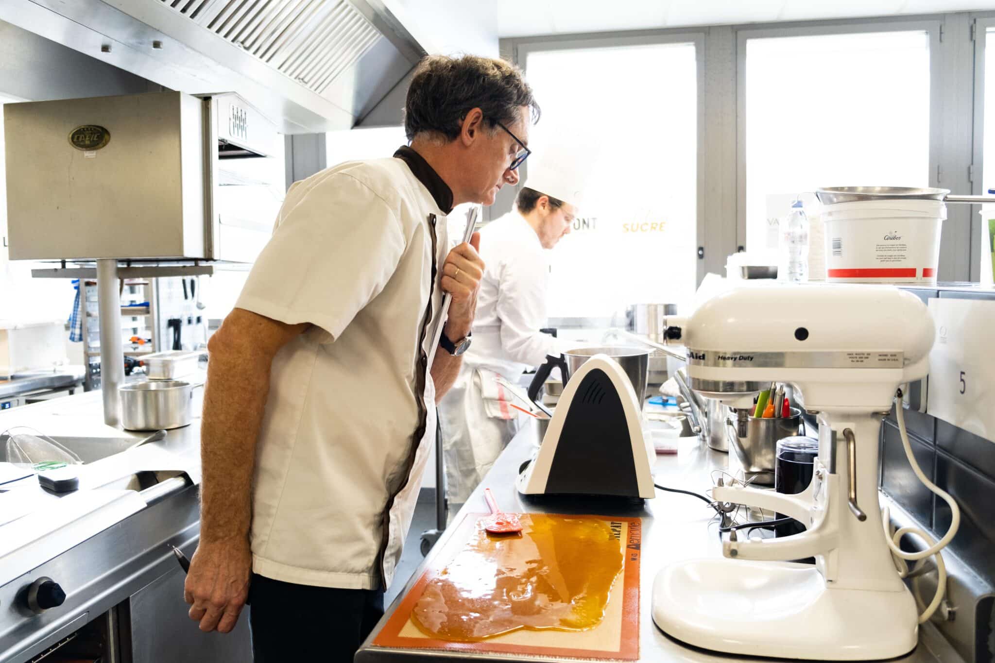 Le jury "technique" Luc Vittoz observe le candidat Alexis Decoret en train de cuisiner pendant l'épreuve.