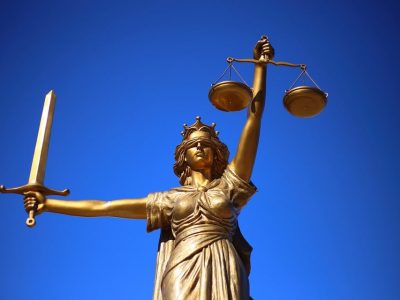 Statut de Thémis, déesse de la Justice, de la Loi et de l'Équité, tenant d'une main un glaive, de l'autre les plateaux d'une balance avec laquelle elle pèse les arguments des parties adverses.